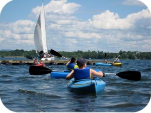 Campers paddling kayaks on Lake Champlain